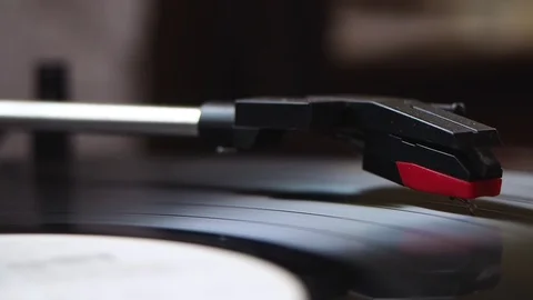 Dusty needle of an old vinyl record player close-up, dark background. Stock Footage 129899593