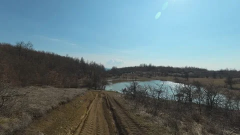Dusty path winds through dry, leafless shrubs. Mount Rtanj Area, Serbia Vidéo 331280203