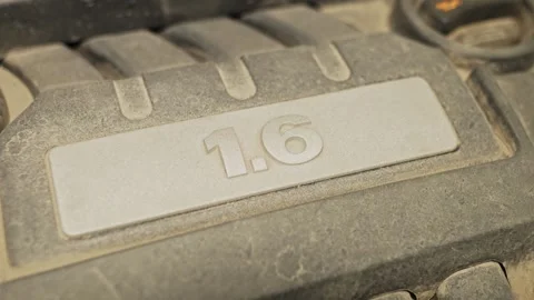 A dusty plastic engine cover features a embossed 1.6 badge. 스톡 동영상 341334530