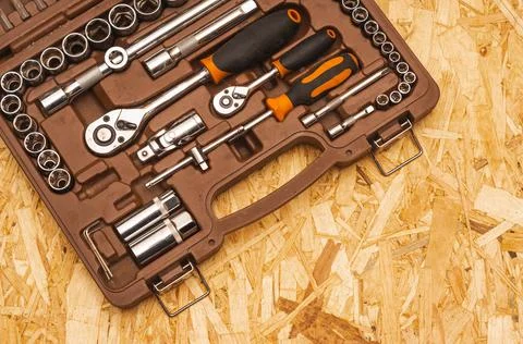 Dusty screwdriver kit in tool box on OSB background. top view Stock Photos