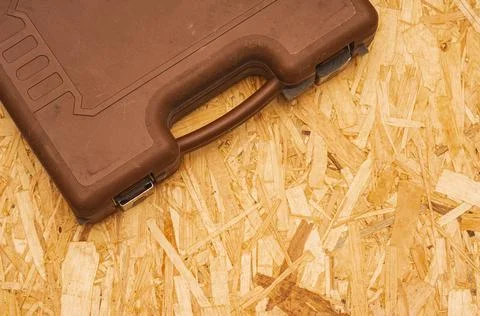 Dusty tool case on OSB background. Top view Stock Photos