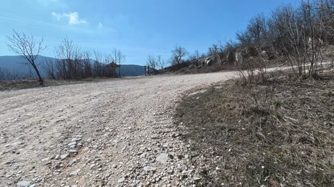 Dusty trail winds through bare brush and stone. Balkan, Eastern Europe, POV Video stock 331451123
