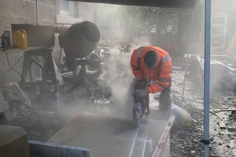 Dusty worksite scene with workers, construction activity and renovation atmos Stock Photos