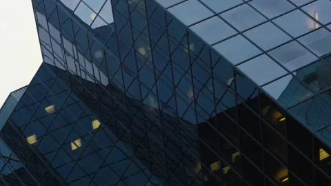 Dutch angle right to left pan over glass tower Stock Footage 132608469