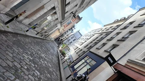 Dutch angle rotating shot of a cobblestone street in Montmartre Vídeos de archivo 332666697