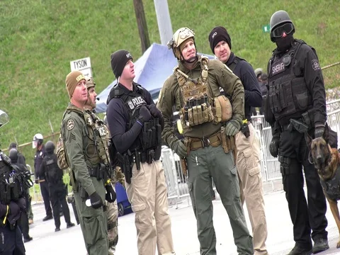 Dutch angle shot of cops at a White-supremacist rally Video stock 81664953