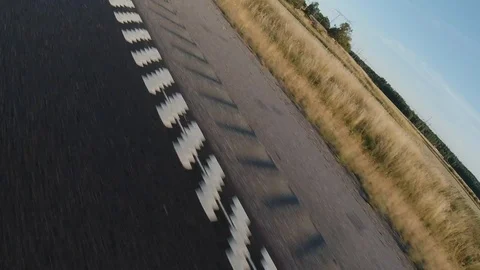 Dutch angle tilt side view asphalt road close up low angle fast car in highway Stock Footage 114037907