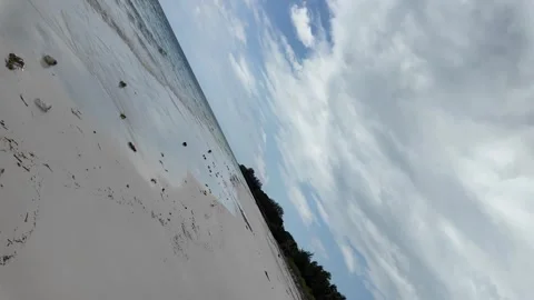 Dutch Angle View of Wide White Sand Beach and Cloudy Sky Stock Footage 268708551
