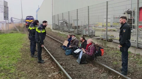 Dutch climate activists blocking the rail tracks used for coal transport Stock Footage 233819679
