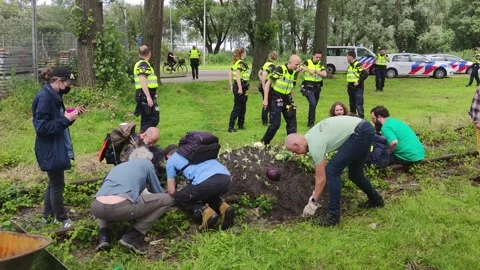 Dutch climate activists getting arrested for damaging the rail tracks Stock Footage 278025387