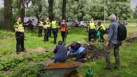 Dutch climate activists getting arrested for damaging the rail tracks Stock Footage 278025388
