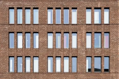 Dutch clinker brick facade in different brown and red tones with high and nar Stock Photos