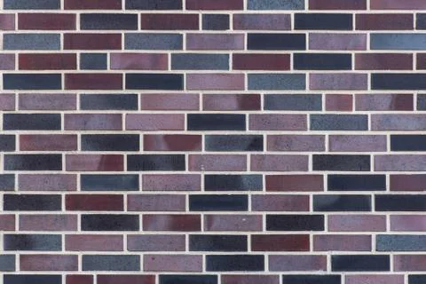 Dutch clinker dark bricks pattern in different tones of dark grey and deep re Stock Photos