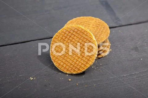 Dutch cookie stroopwafels on black wooden background Stock Photos