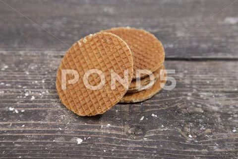 Dutch cookie stroopwafels on brown wooden background Stock Photos