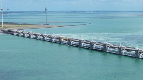 Dutch Eastern Scheldt storm surge barrier with wind turbines generating 動画素材 338119978