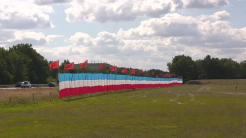 Dutch flag hangs upside alongside the highway as a  farmers protest Stock Footage 205879086