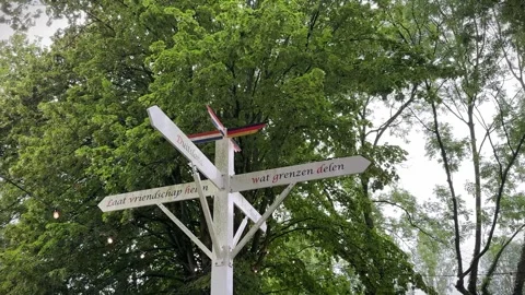 Dutch-German border sign with the flags near Hommersum village, Germany Stock Footage 282441414