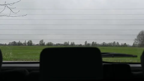 Dutch landscape through the rear view mirror of a car on a rainy day Stock Footage 273219035