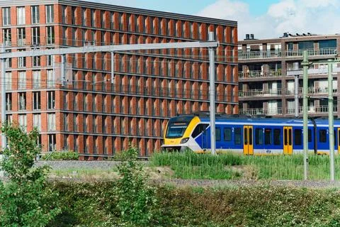 Dutch NS Train Passing Modern Residential Buildings Stock Photos