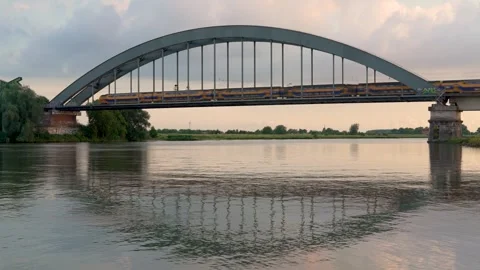 Dutch train crossing the bridge over the Lek river in the city of Culemborg Stock Footage 280382275