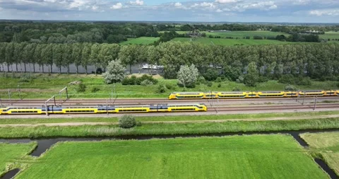 Dutch train in green open grassland landscape. Green alternative sustainable Stock Footage 201910722
