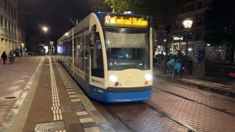 Dutch tram passing by at night Stock Footage 318411332