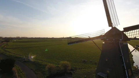 Dutch windmill with bokeh effect blue sky and green grass shot by drone 動画素材 128385420