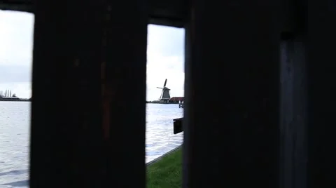 Dutch Windmill in distance view through the slot Stock Footage 47619284