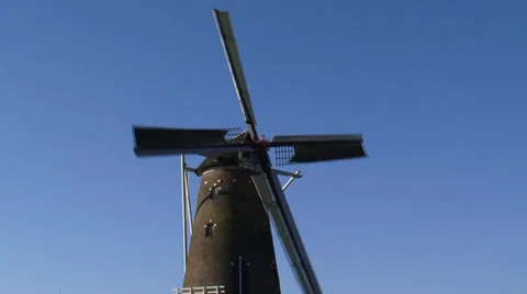 Dutch Windmill in operations against blue sky Stock Footage 34660788