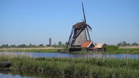 Dutch windmill over river waters Stock Footage 112305332