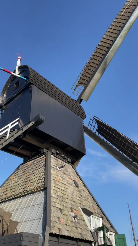 A dutch windmill rotating in the blue sky, tourist experience Video stock 295361507