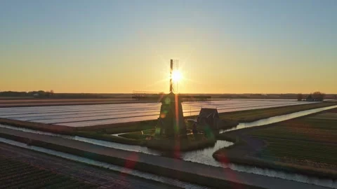 Dutch windmill silhouette in tulip fields at sunrise Stock Footage 340348212