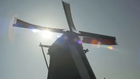 Dutch Windmill with Sun Rays passing through Blades Stock Footage 92078918