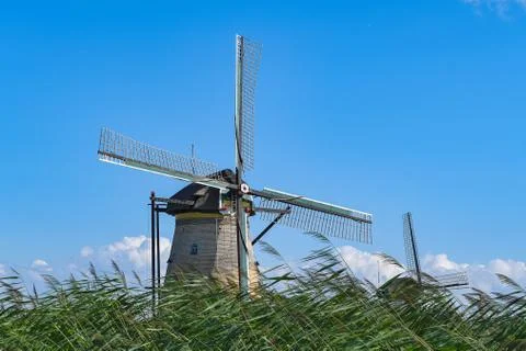 Dutch windmills in grass Stock Photos