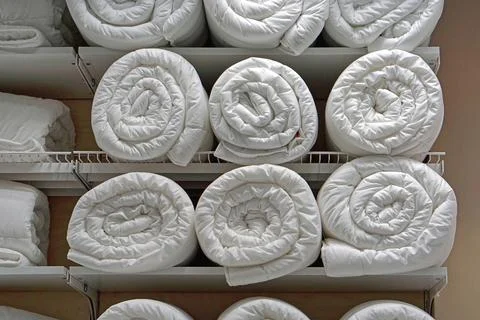 Duvets in rolls Stock Photos