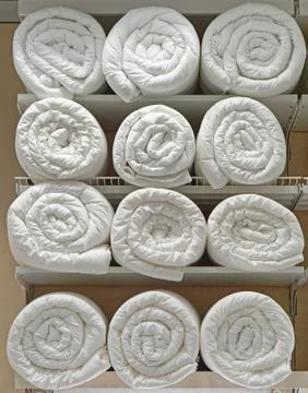 Duvets rolls shelf Stock Photos