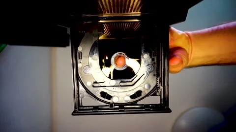 DVD Disc Removed From Drive, Camera Looking Up, Soft Yellow Light, HD Stock Footage 234478966