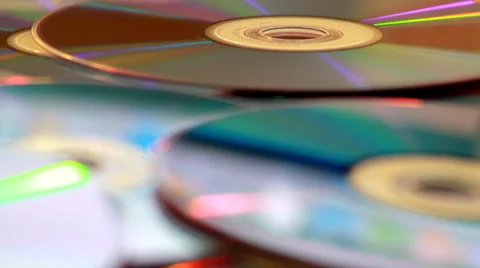 DVDs and CDs in a Pile Pull Focus Stock Footage 39377342
