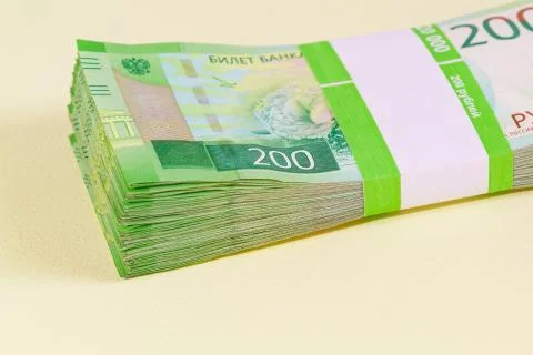 Dvuhmatchevyh bundle of banknotes in the banking package lies on the yellow t Stock Photos