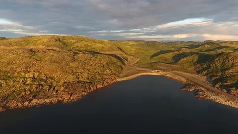 Dwarf birch, moss-covered stones. A large lake in Russia, Murmansk region, Kola Stock Footage 104546384