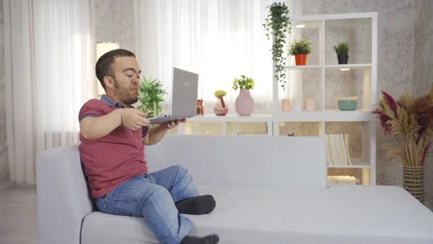 Dwarf man using laptop at home, happy dwarf man. 動画素材 230965976