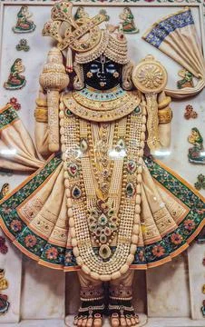 Dwarkadhish krishna deity adorned with white garments and traditional jewelry Stock Photos