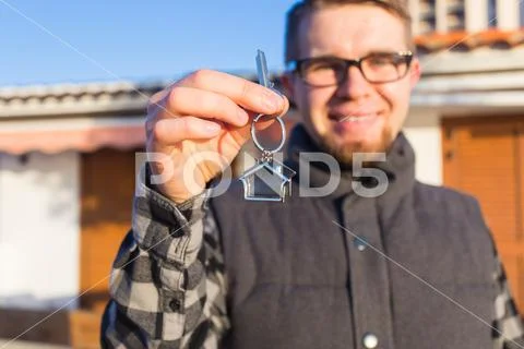 Dwelling, buying home, real estate and ownership concept - handsome man showing Stock Photos