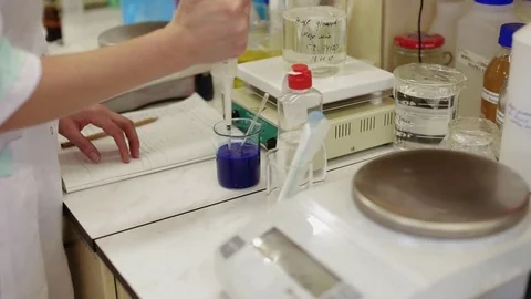 Dye dissolution in a beakers in modern laboratory Stock Footage 83640549