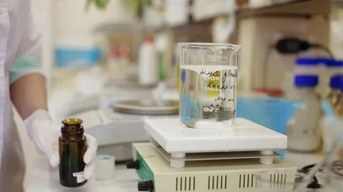 Dye dissolution in a glass in a modern laboratory Stock Footage 83528902