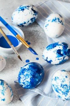 Dyed Easter eggs. ?lassic blue Easter eggs on the grey background. Blue speck Stock Photos
