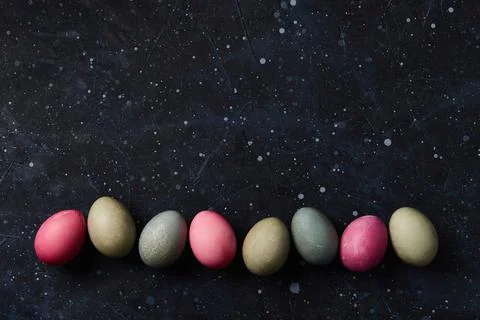 Dyed eggs on black background. Easter celebration concept Foto stock