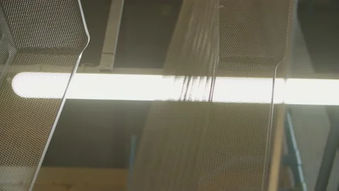Dyed wired mesh cages moving on the track in the factory Stock-Footage 153468454