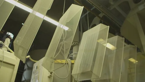 Dyed wired mesh cages moving on the track in the factory Stock Footage 153468556